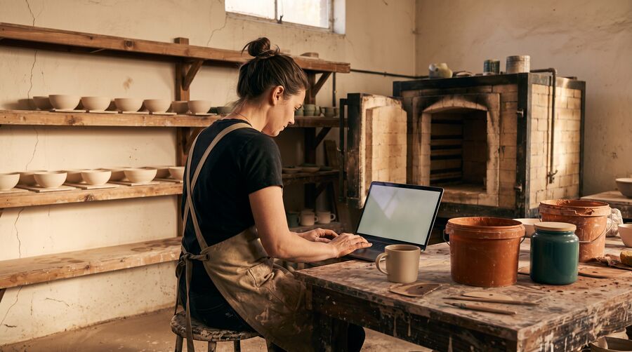 A shelf of handmade bowls drying in a pottery studio